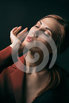 A woman holds her hand with a sore neck, arthrosis, osteochondrosis.