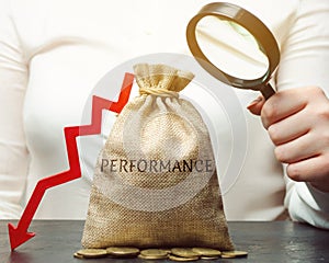 A woman holds a magnifying glass over a bag with the word Performance and an arrow down. The concept of low productivity and