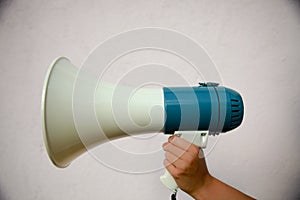 A woman holds a megaphone in her hand