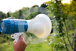 A woman holds a megaphone in her hand