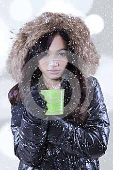 Woman holds mug with hot tea