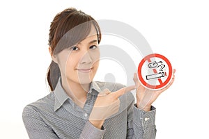 Woman holds non smoking sign