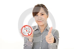 Woman holds non smoking sign