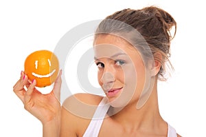 Woman holds orange with smile