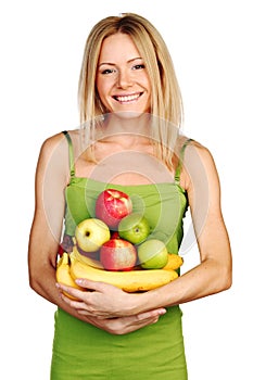 Woman holds a pile of fruit