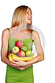 Woman holds a pile of fruit