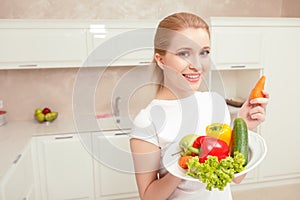 Woman holds plate with vegetables