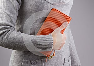 Woman holds a purse in hands