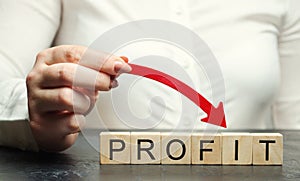 A woman holds a red down arrow above the word Profit. Unsuccessful business and poverty. Profit decline. Loss of investment. Low