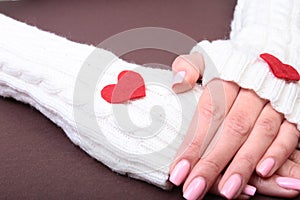 A woman holds a red heart in her hands