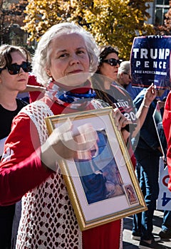 A Woman Holds a Religious Picture at a Stop the Steal Rally