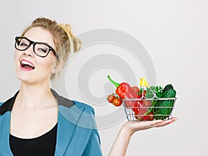 Woman holds shopping basket with vegetables