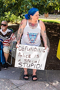 A Woman Holds a Sign Against Defunding the Police