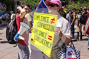 A Woman Holds a Sign Protesting Mask Mandates