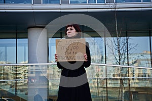 Woman holds sign saying