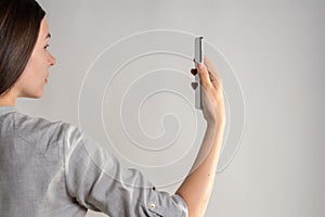 woman holds the smartphone in front of her eyes and unlocks the phone via face id.