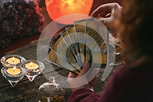 Woman holds tarot cards in her hands