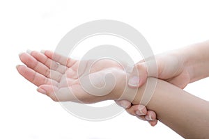 The woman holds on to the sore wrist at white background