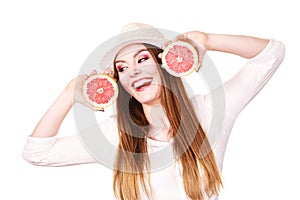 Woman holds two halfs of grapefruit citrus fruit in hands