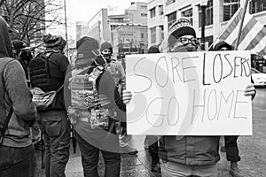 Woman Holds up a Sign `Sore Losers Go Home` at an Armed Demonstration at the Ohio Statehouse Ahead of Biden`s Inauguration