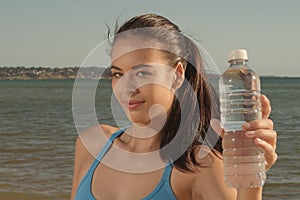 Woman holds water bottle