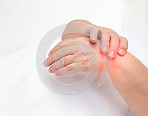Woman holds on wrist joint on a white background. The concept of pain and inflammation of the wrist joint, tunnel syndrome and
