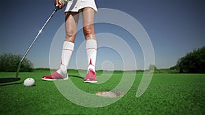 Woman holes out with a putt