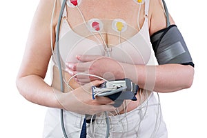 Woman with holter monitor device for daily monitoring of electrocardiogram and blood pressure