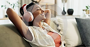 Woman, home with headphones and music, happy to relax on sofa with entertainment and peace. Energy, hip hop and listen