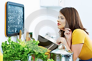 Woman in home kitchen cooking bio diet