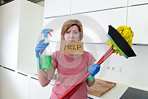 Woman at home kitchen in gloves with cleaning broom and mop asking for help