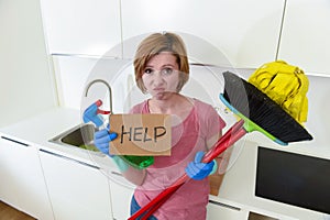 Woman at home kitchen in gloves with cleaning broom and mop asking for help