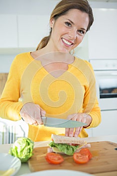 woman at home making sandwich