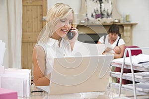 Woman in home office with mother and baby