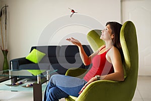 Woman home owner playing with keys of new house on sofa