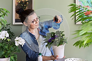 Woman with home plants in pots, hobbies and leisure