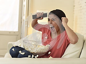 Woman at home sofa couch watching excited tv football sport celebrating victory