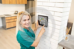 Woman at home using smart screen, automation domestic system