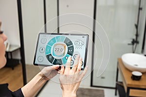 Woman at home using smart screen, automation domestic system