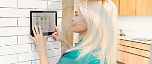 Woman at home using smart screen, automation domestic system