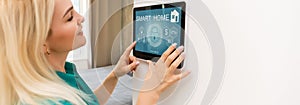 Woman at home using smart screen, automation domestic system