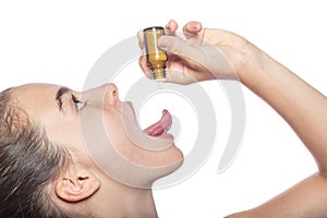 Woman with a homeopathic globules on the tip of her tongue