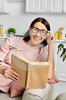 Woman in homewear engrossed in book photo