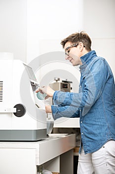 Woman hone the edge of the eyeglasses photo