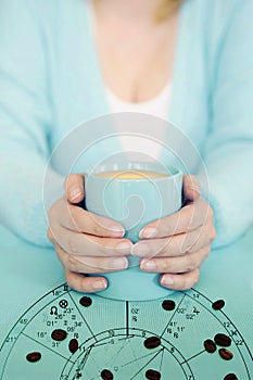 Woman with hooscope and coffee mug in aquamarine coloring