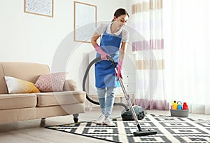 Woman hoovering carpet. Cleaning service