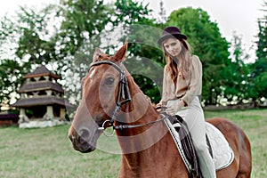 Woman with horse in countryside. A charming female rider on her horse. Equestrianism fosters well-being, relaxation. Young lady