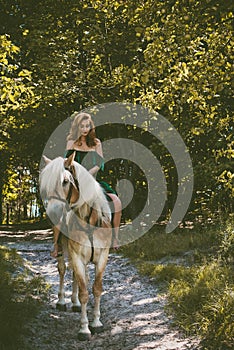 Woman with a horse at forest, mystical scene