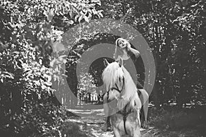 Woman with a horse at forest, mystical scene