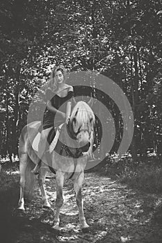 Woman with a horse at forest, mystical scene